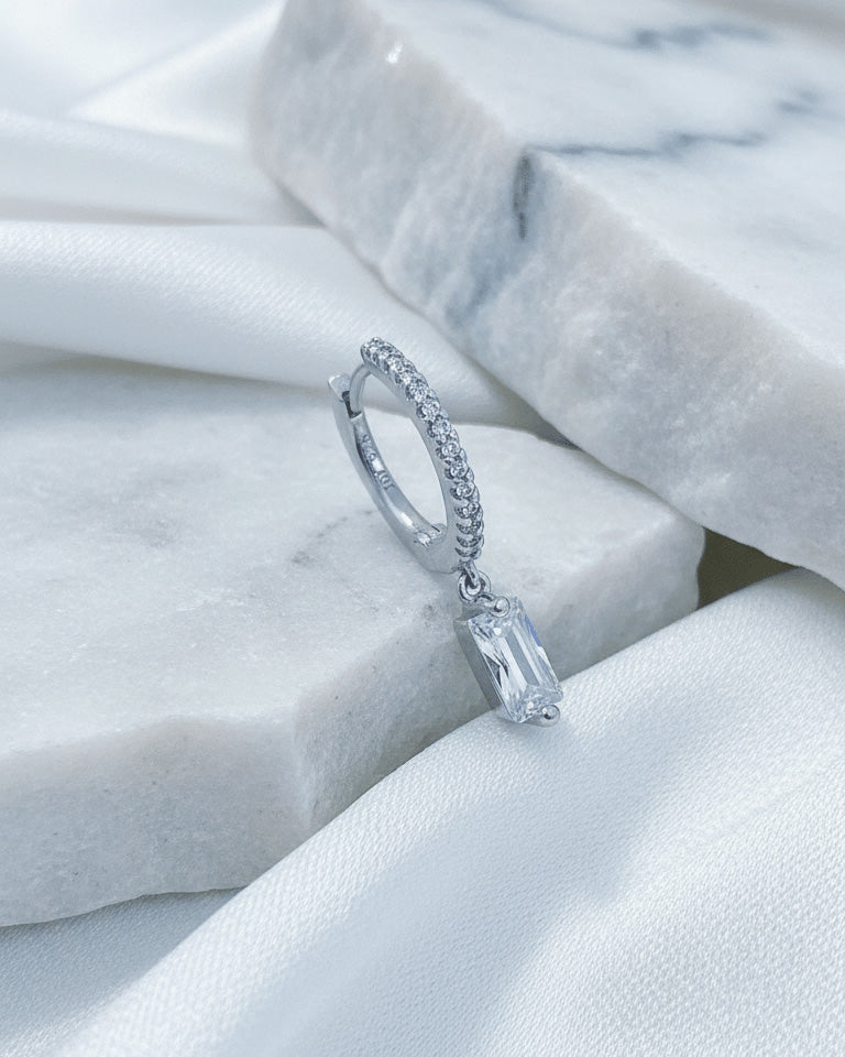 10 mm CZ hoop with dangling rectangular baguette shape stone.