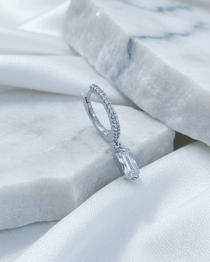 10 mm CZ hoop with dangling rectangular baguette shape stone.