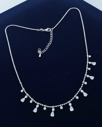 Beads style silver necklace of dangling pear and round shape CZ.