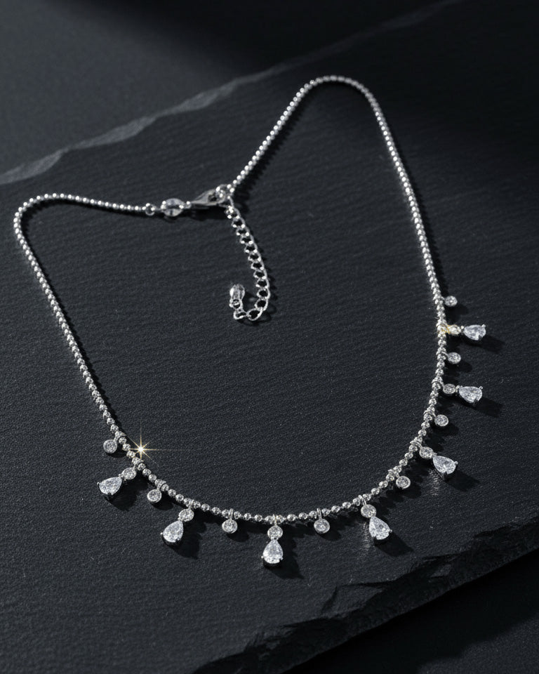Beads style silver necklace of dangling pear and round shape CZ.