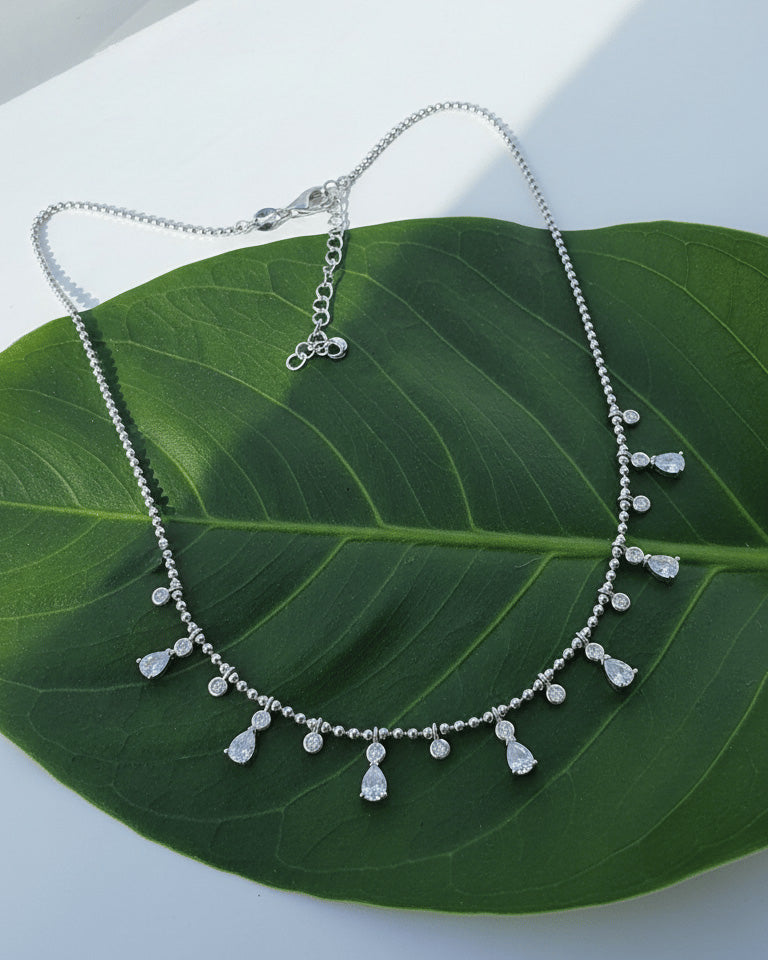 Beads style silver necklace of dangling pear and round shape CZ.