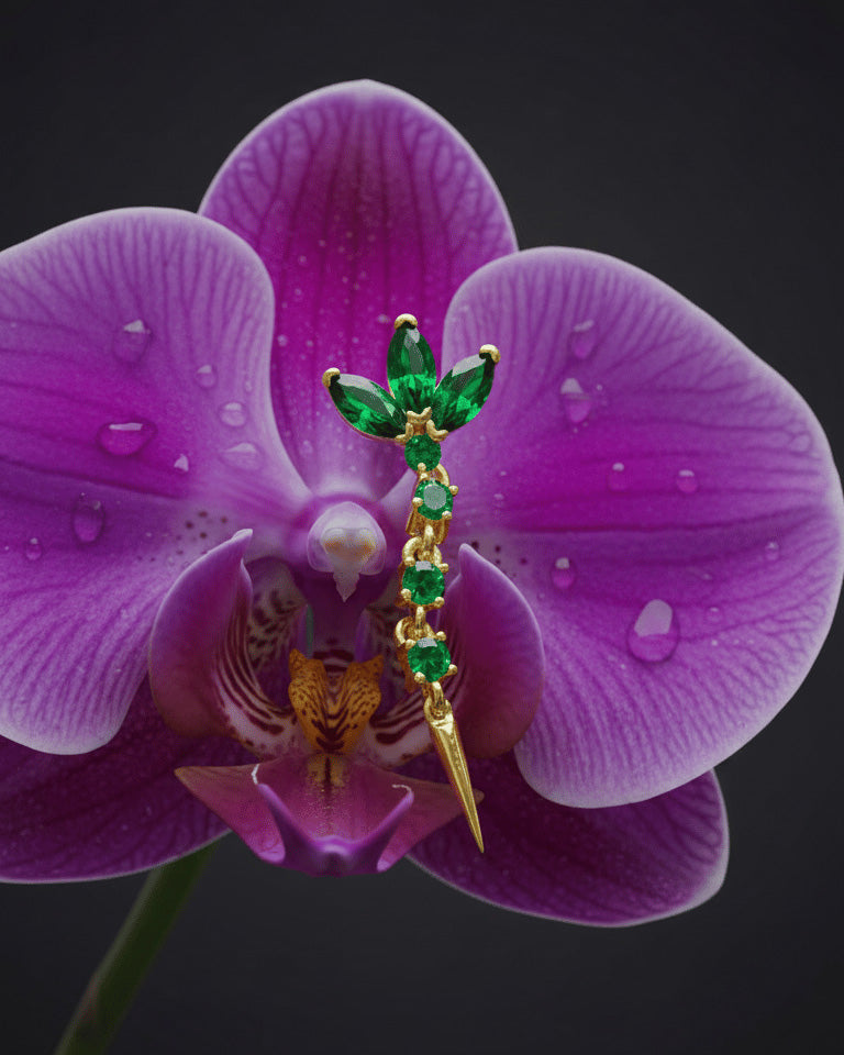 lotus shape stud earring with dangling line of emerald color stones.