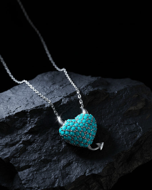 a horned turquoise studded heart shape necklace.