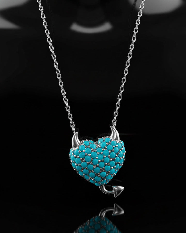 a horned turquoise studded heart shape necklace.