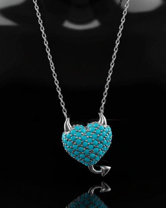 a horned turquoise studded heart shape necklace.