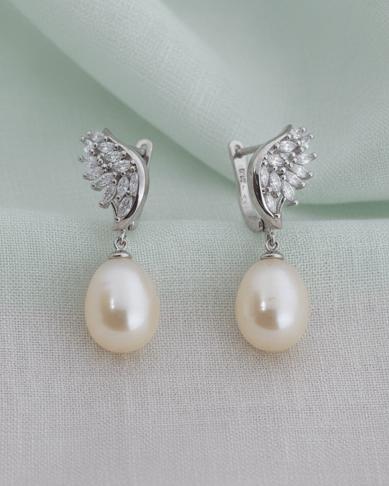 wings shape marquise clip-on earrings with dangling pearls.