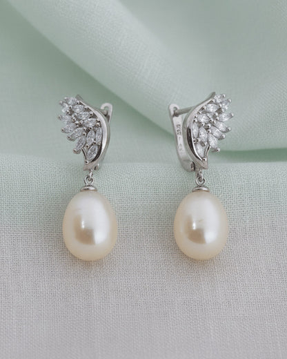 wings shape marquise clip-on earrings with dangling pearls.