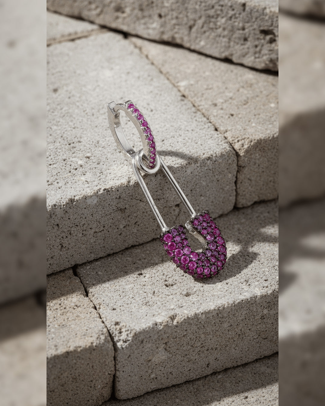 8 mm colored CZ huggie hoop with dangling safety pin shape.