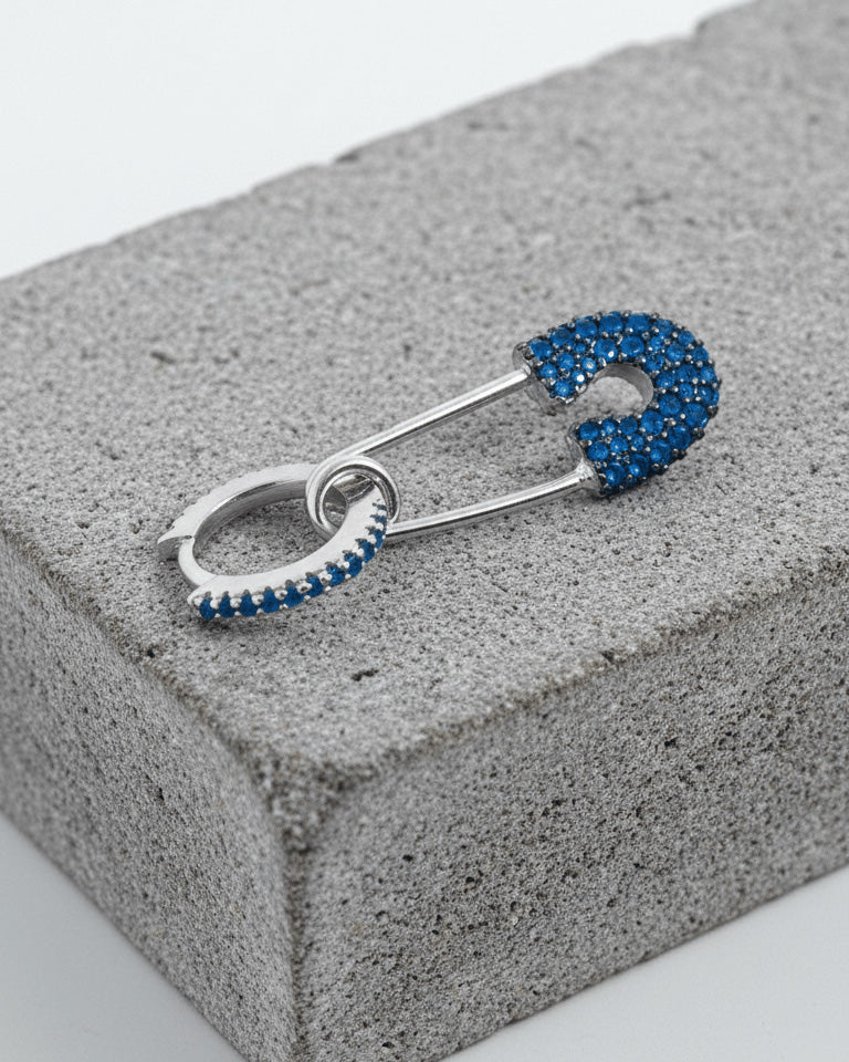 8 mm colored CZ huggie hoop with dangling safety pin shape.