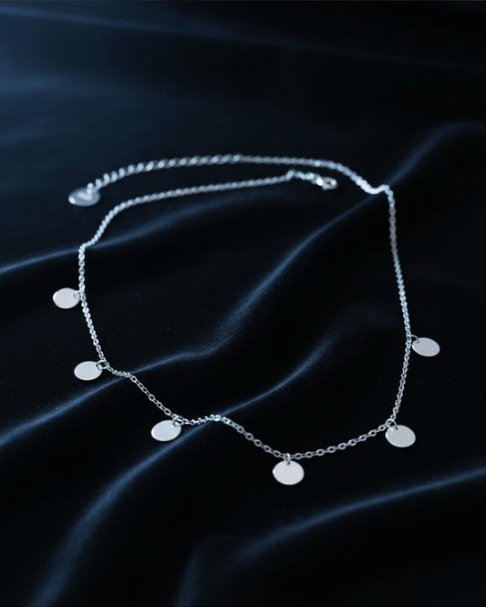 delicate necklace of dangling plain coins.
