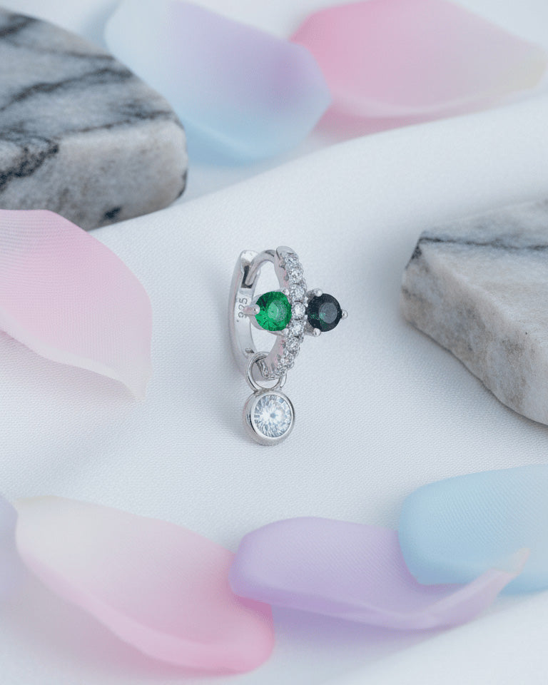 Huggie hoop of green and black stones with dangling detachable round stone in bezel setting.