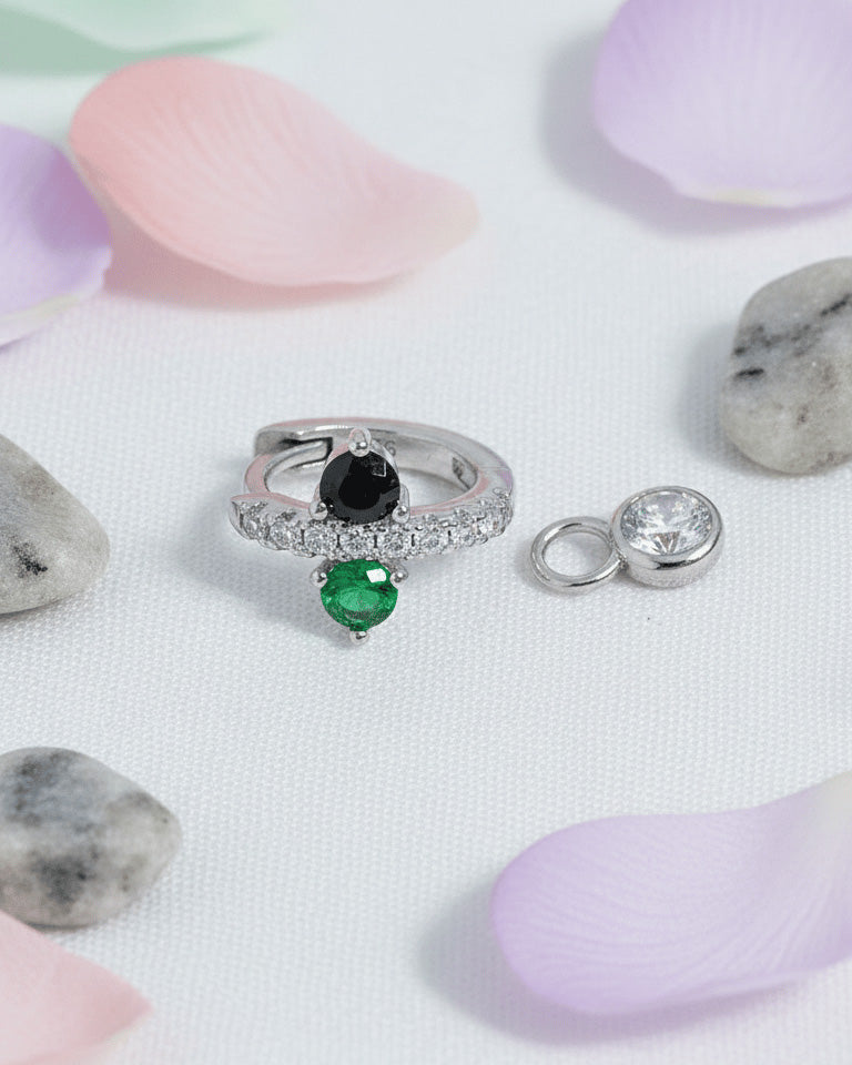 Huggie hoop of green and black stones with dangling detachable round stone in bezel setting.