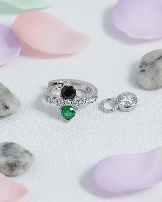 Huggie hoop of green and black stones with dangling detachable round stone in bezel setting.