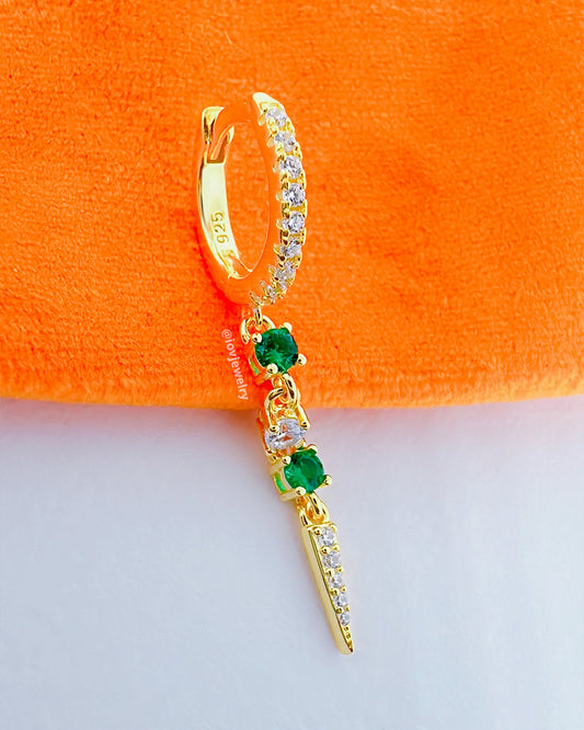 CZ huggie hoop with dangling emerald color and white stones.