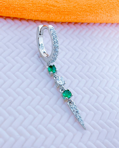 CZ huggie hoop with dangling emerald color and white stones.