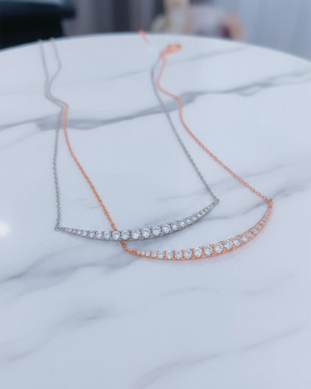 curved bar of graduated cz stones necklace.