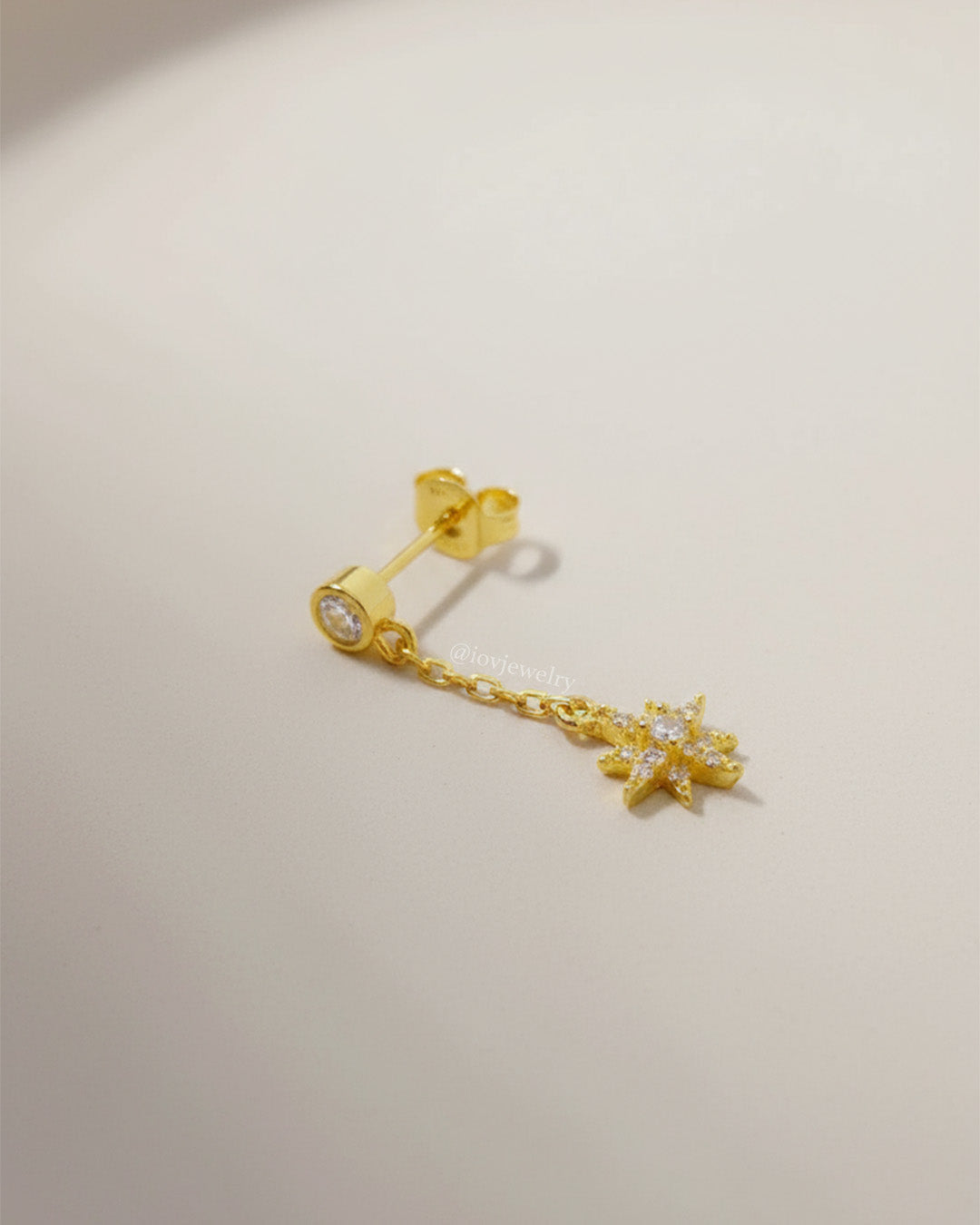 CZ round stone in bezel setting with delicate dangling star shape stud earring.