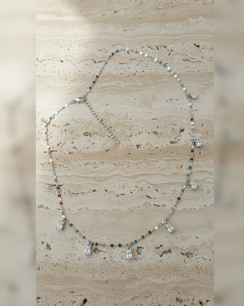 mirror link chain with dangling CZ oval shape stones.
