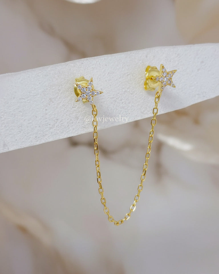 double CZ star stud earring linked with a delicate chain.
