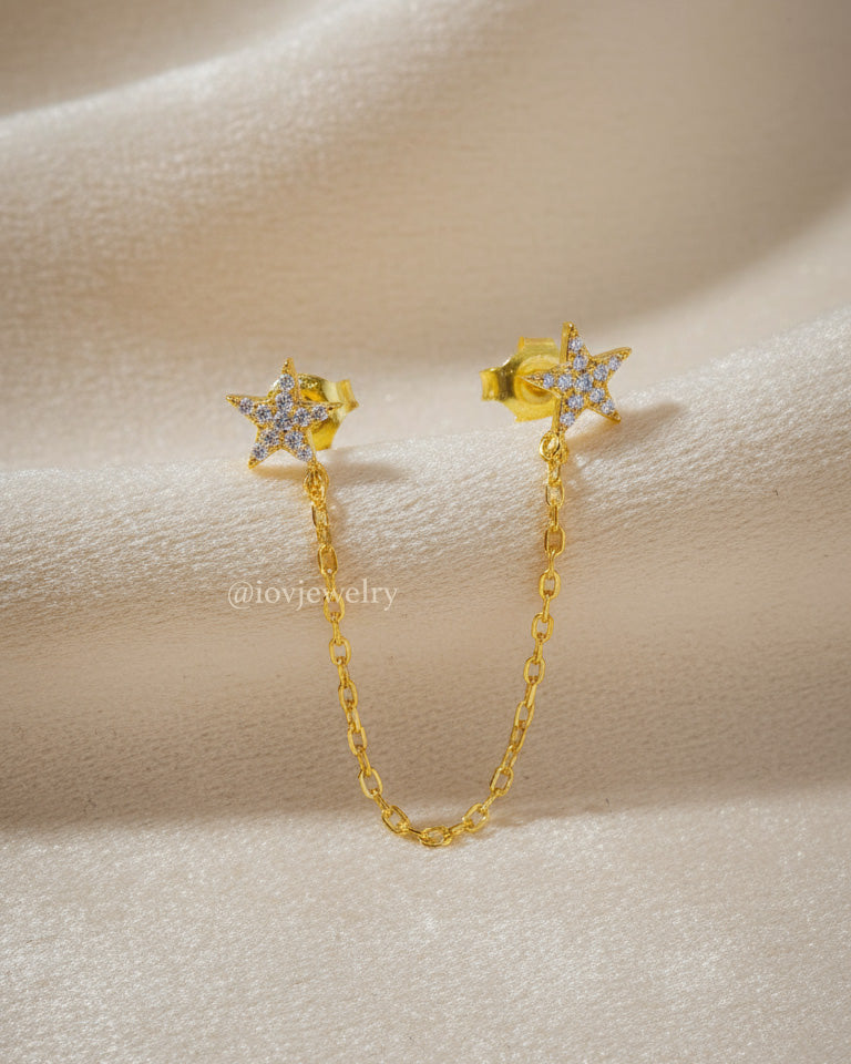 double CZ star stud earring linked with a delicate chain.