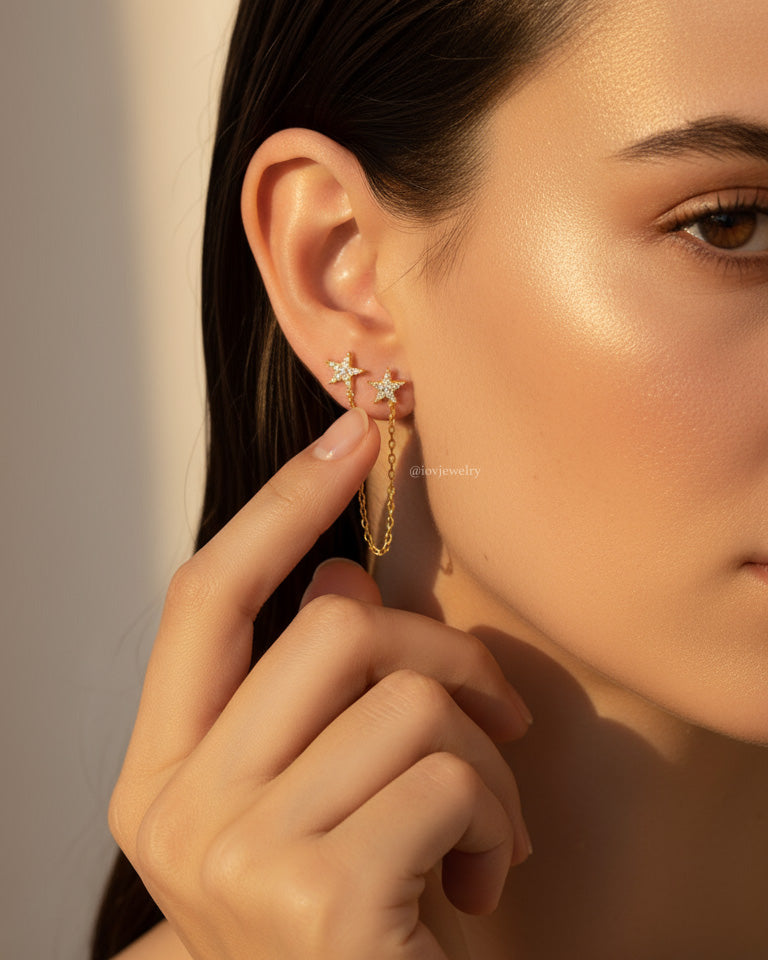 double CZ star stud earring linked with a delicate chain.