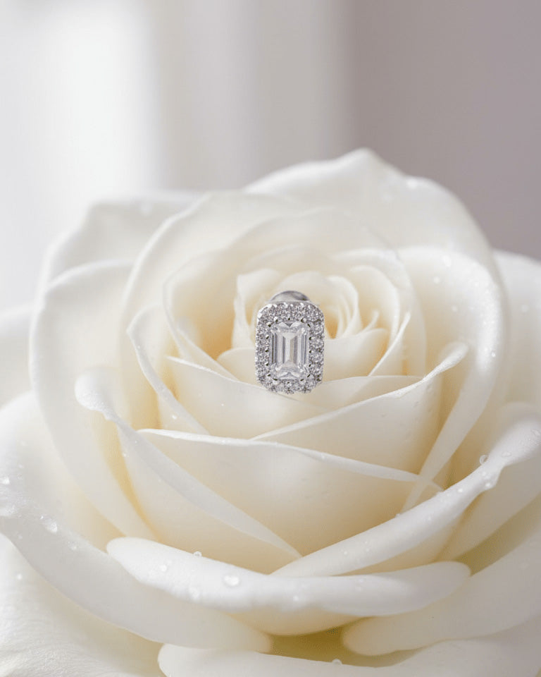 emerald cut stone in a halo setting stud earring.