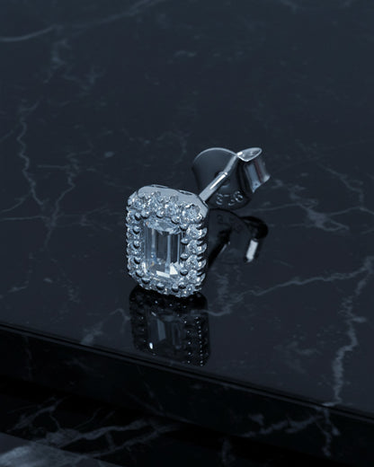 emerald cut stone in a halo setting stud earring.