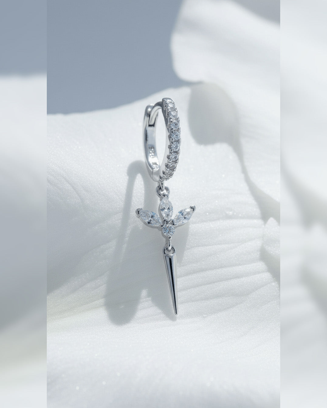 CZ huggie hoop with dangling lotus shape.