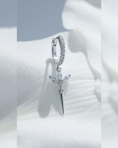 CZ huggie hoop with dangling lotus shape.
