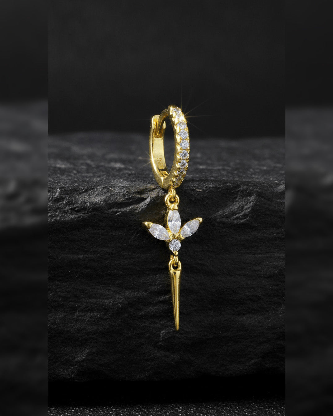 CZ huggie hoop with dangling lotus shape.