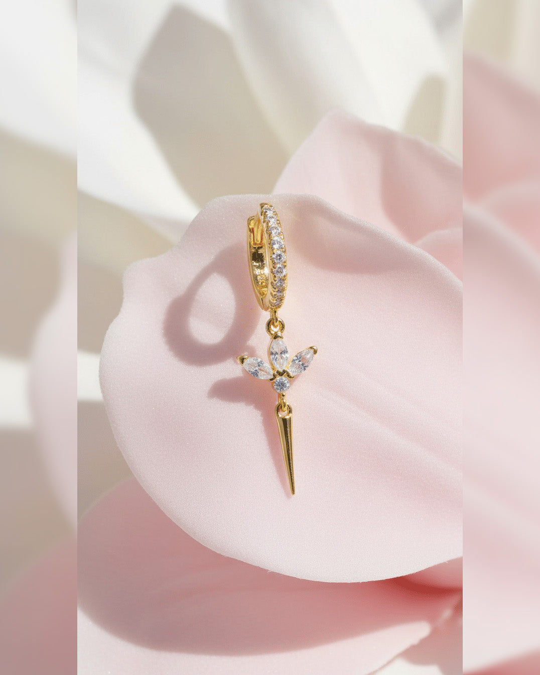 CZ huggie hoop with dangling lotus shape.