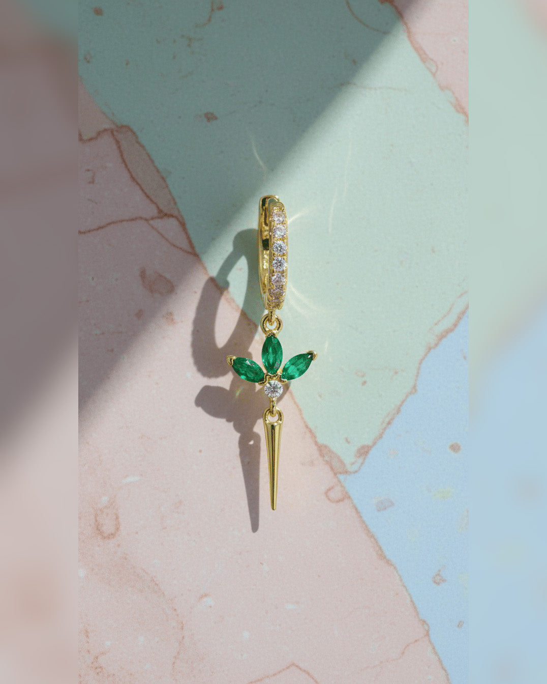 CZ huggie hoop with dangling lotus shape.