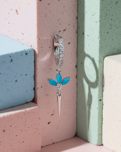 CZ huggie hoop with dangling lotus shape.