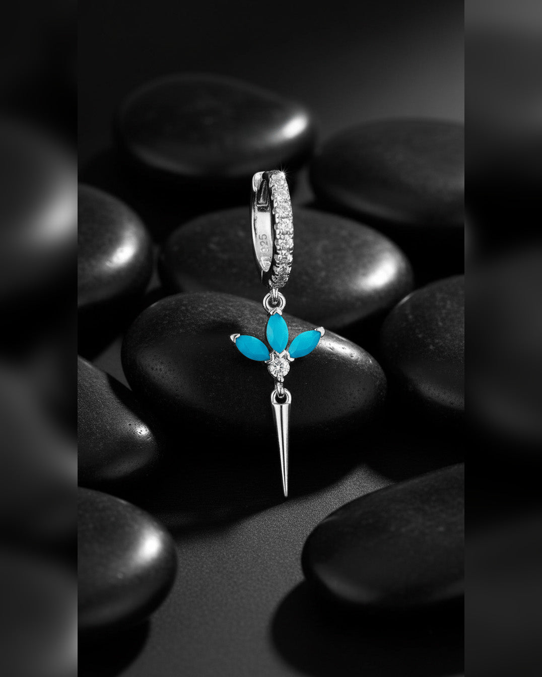 CZ huggie hoop with dangling lotus shape.