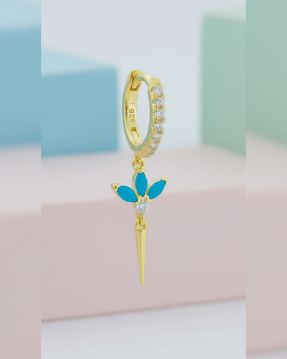 CZ huggie hoop with dangling lotus shape.