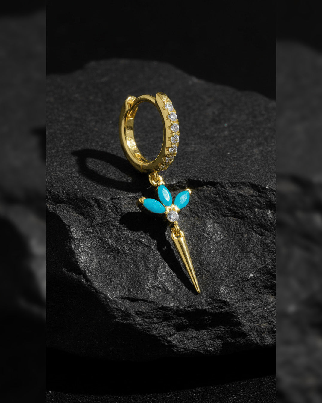 CZ huggie hoop with dangling lotus shape.