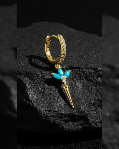 CZ huggie hoop with dangling lotus shape.