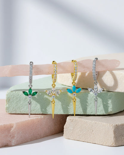 CZ huggie hoop with dangling lotus shape.