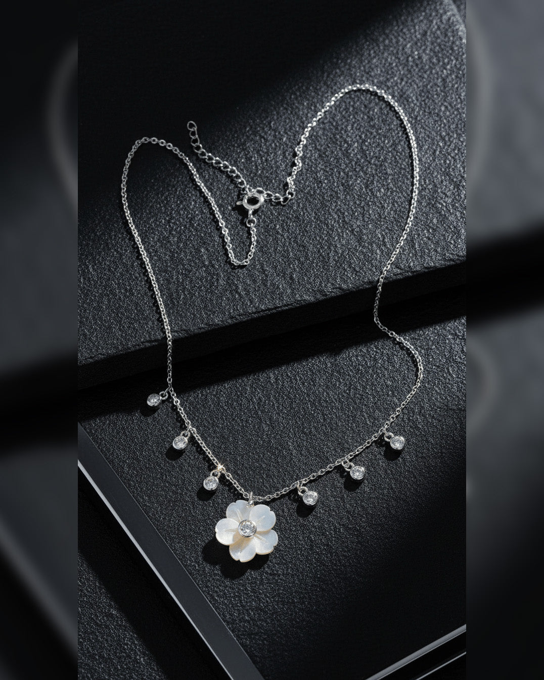 mother of pear flower shape necklace with dangling round CZ in bezel setting.