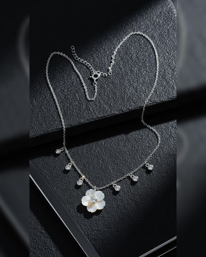 mother of pear flower shape necklace with dangling round CZ in bezel setting.