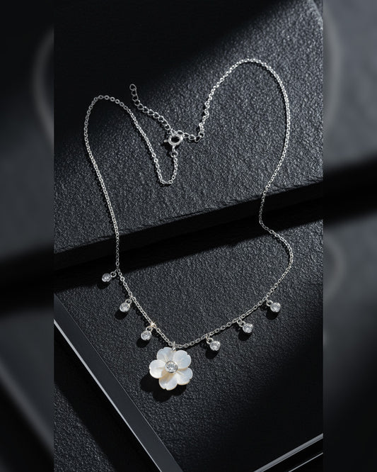 mother of pear flower shape necklace with dangling round CZ in bezel setting.