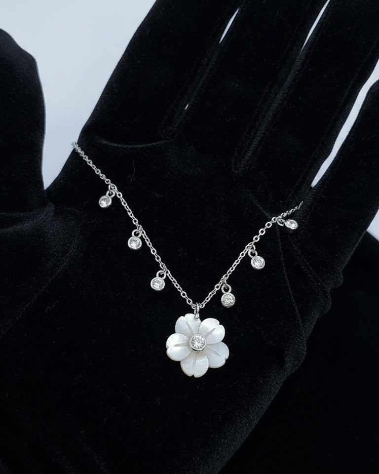 mother of pear flower shape necklace with dangling round CZ in bezel setting.
