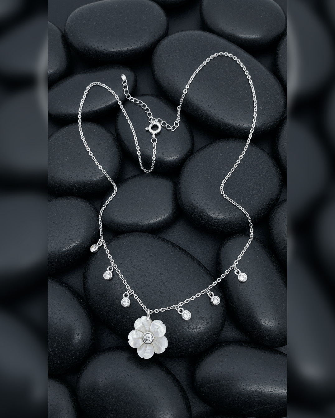 mother of pear flower shape necklace with dangling round CZ in bezel setting.