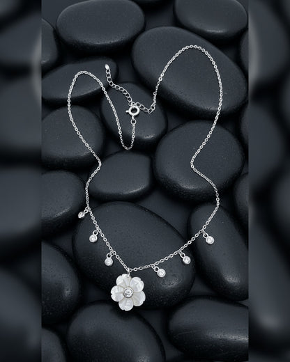 mother of pear flower shape necklace with dangling round CZ in bezel setting.