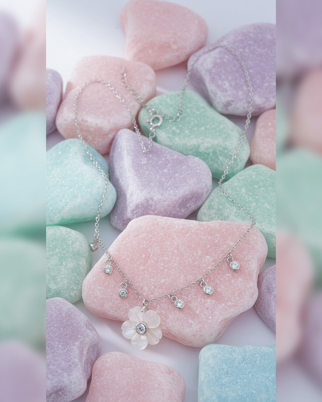 mother of pear flower shape necklace with dangling round CZ in bezel setting.