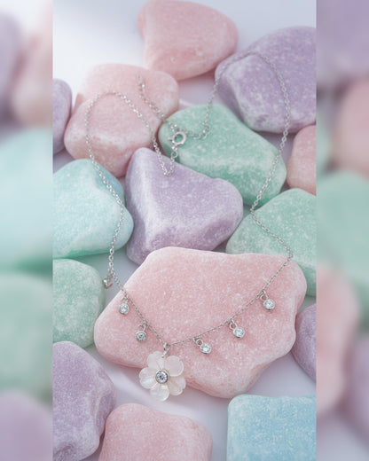 mother of pear flower shape necklace with dangling round CZ in bezel setting.