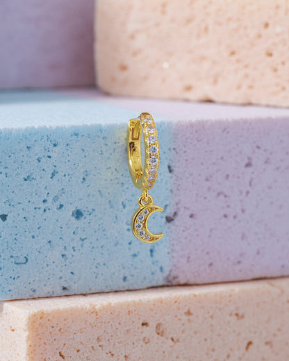 CZ huggie hoop with dangling small crescent shape.