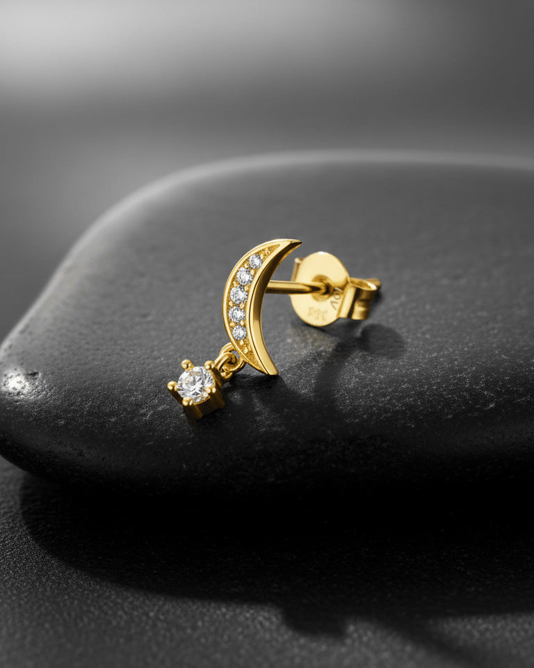 crescent shape with dangling round stone.