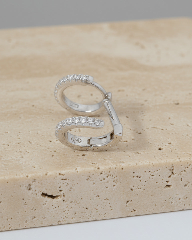 doucble huggie hoops of one piercing earring.