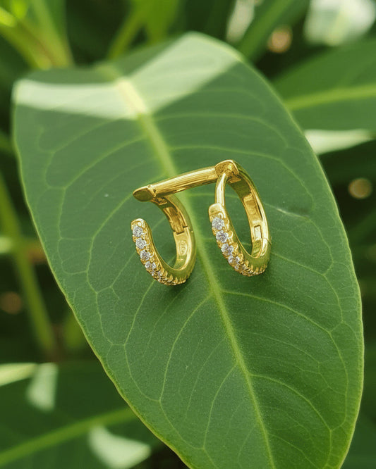 doucble huggie hoops of one piercing earring.
